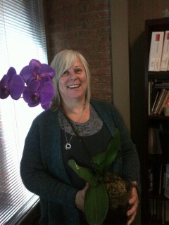 No more drowning: Carolyn holds her healthy orchid. 
